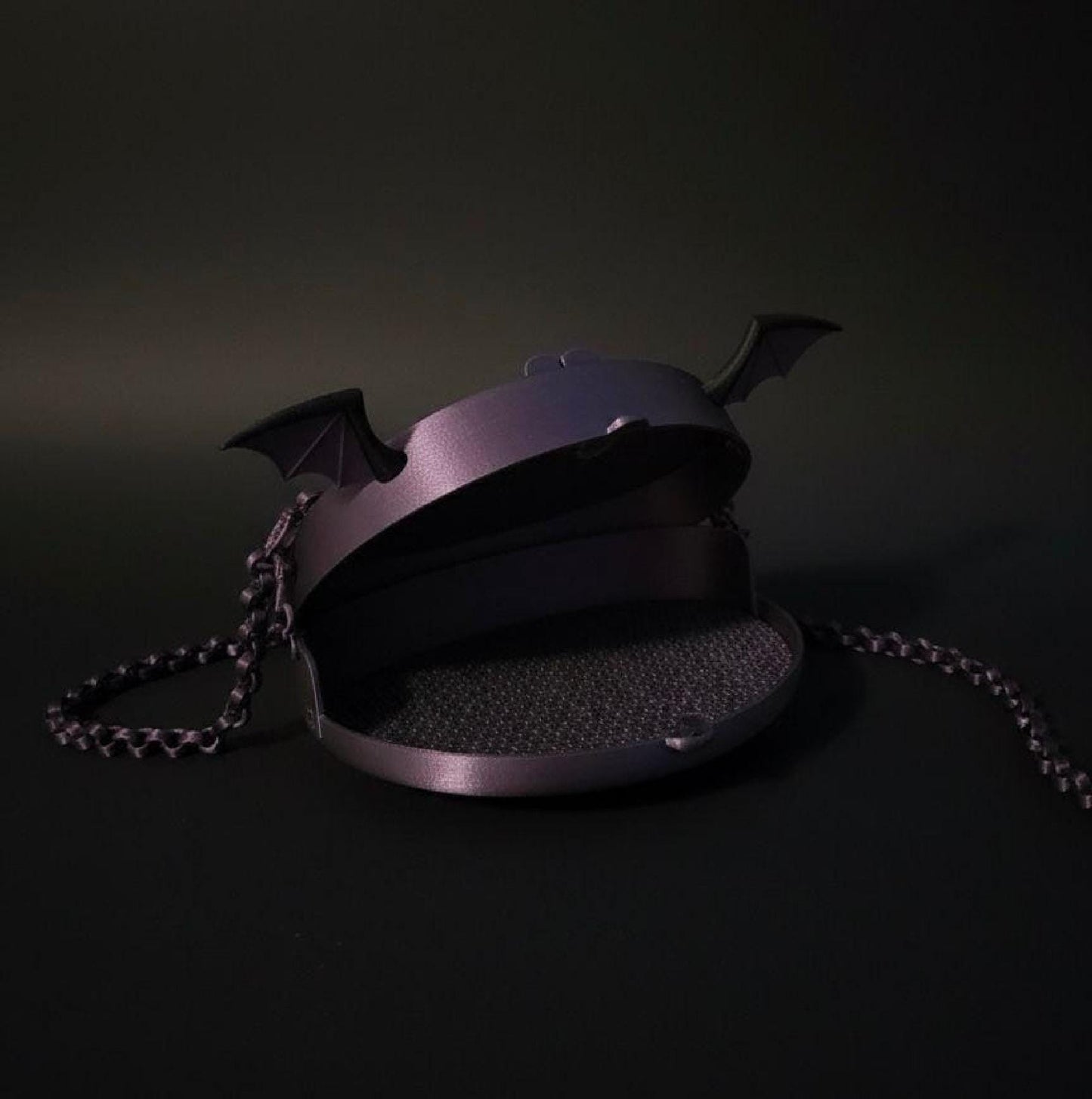Purple bat-wing mesh purse with 3D-printed bat ears, black trim, and matching chain strap.